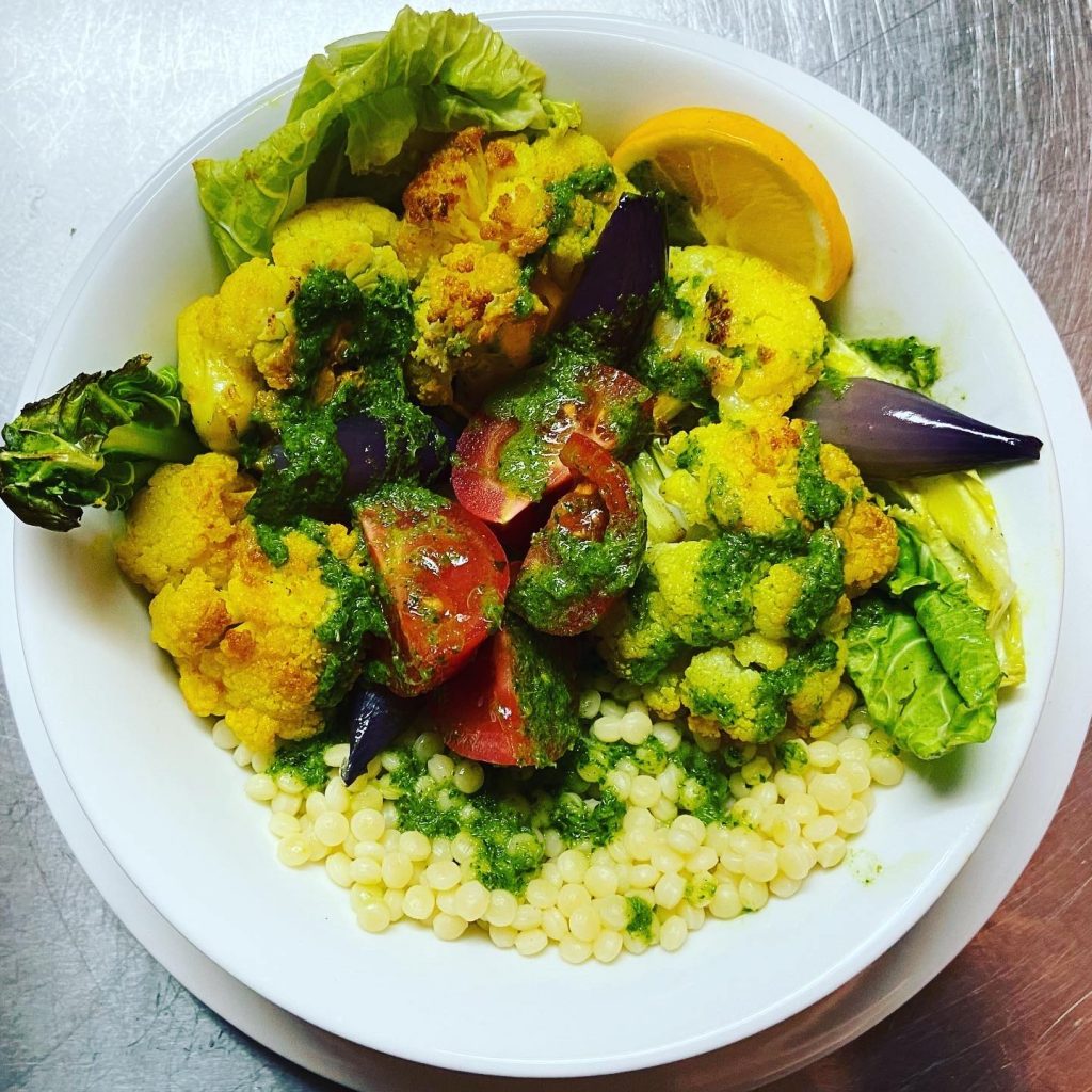 roasted cauliflower bowl with couscous and zhoug